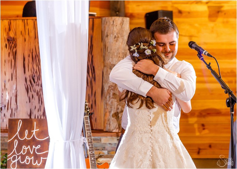 bride hugs twin brother tight after he performs song for them at Club Lake Plantation wedding reception