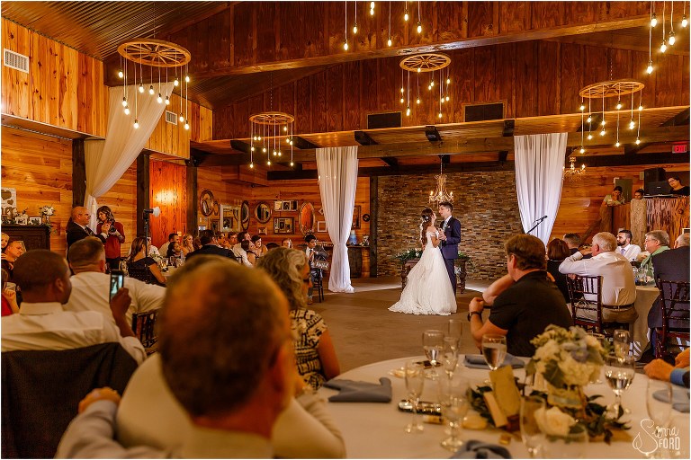 couple shares first dance as husband & wife as guests look on lovingly at Club Lake Plantation wedding reception