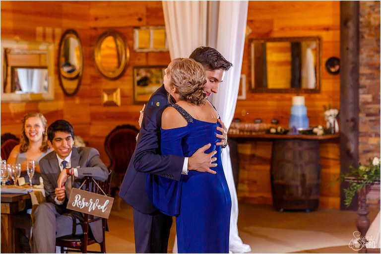 groom hugs his mother during their dance together at Club Lake Plantation wedding reception