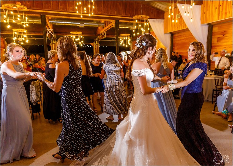 bride & her mother boogie down surrounded by other mother/daughter pairs at Club Lake Plantation wedding reception