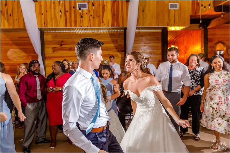 crowd looks on while bride & groom bust out their dance moves at Club Lake Plantation wedding reception