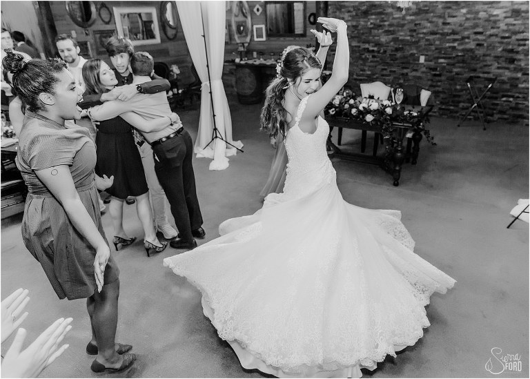 friends cheer as bride twirls in her gown on the dance floor at Club Lake Plantation wedding reception