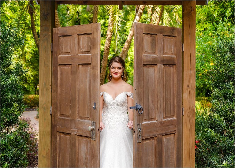 bride comes through wooden doors in Secret Garden before Club Lake Plantation wedding