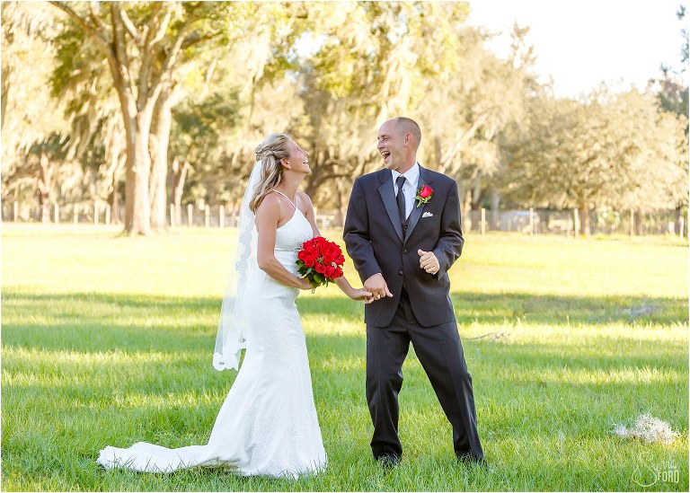 bride & groom laugh & dance together at Central Florida winery wedding