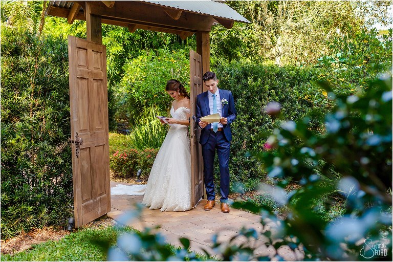 bride & groom read letters to each other in Secret Garden before Club Lake Plantation wedding