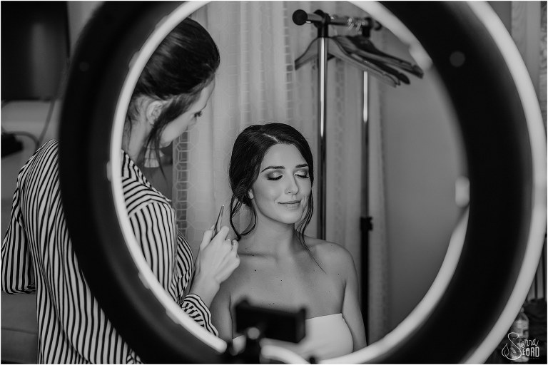 makeup artist, Ashley Sellars, puts finishing touches on bride before Amelia Island wedding