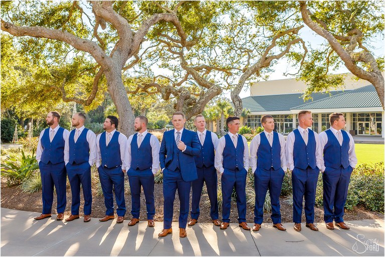 groom & groomsmen stand among oak trees in blue suits at Amelia Island wedding