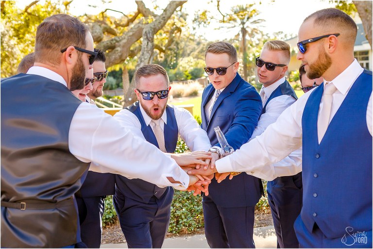 groom & groomsmen put their hands in for a cheer before Amelia Island wedding