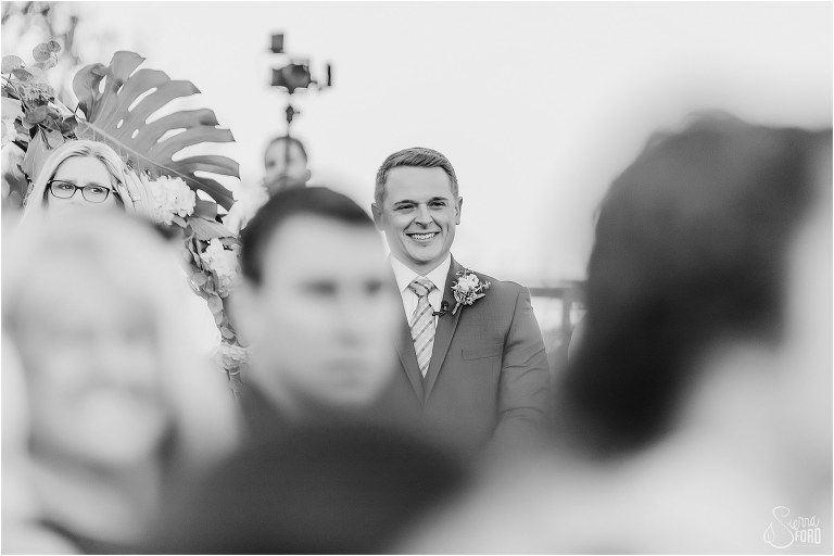 groom smiles from ear to ear as he sees bride walk down aisle at Amelia Island wedding