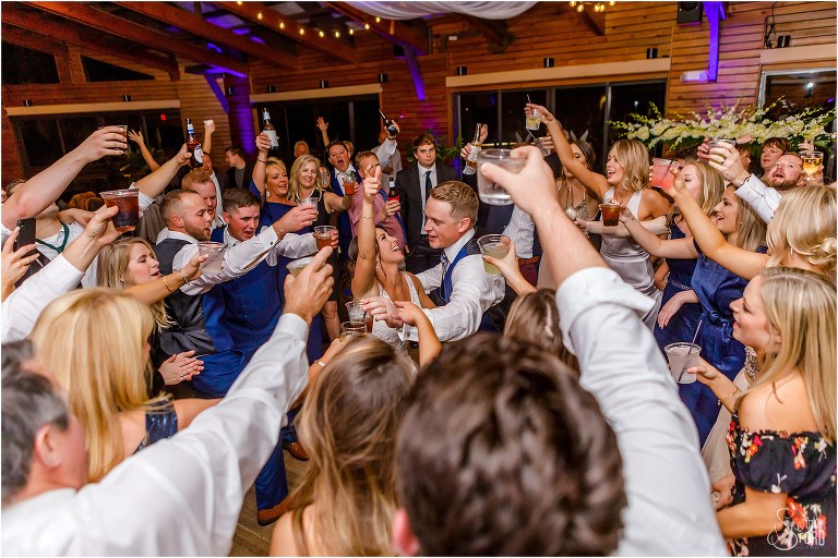 bride & groom dance surrounded by guests at Amelia Island wedding reception