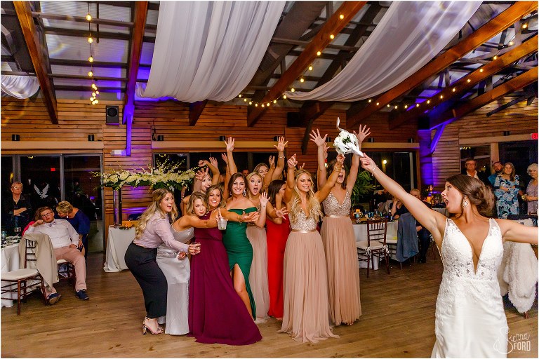 girls reach for bouquet as bride throws it at Amelia Island wedding reception
