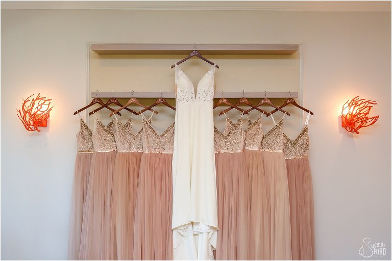bride's Essence of Australia gown hung next to BLHDN bridesmaids dresses before Amelia Island wedding