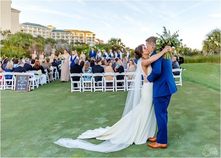 bride & groom kiss at end of aisle after their Amelia Island wedding ceremony