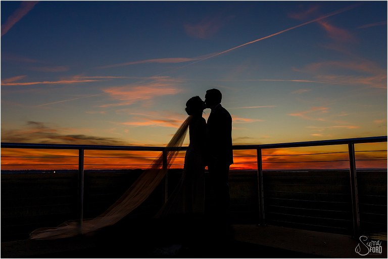 bride & groom silhouetted by gorgeous orange and blue sunset at Amelia Island wedding