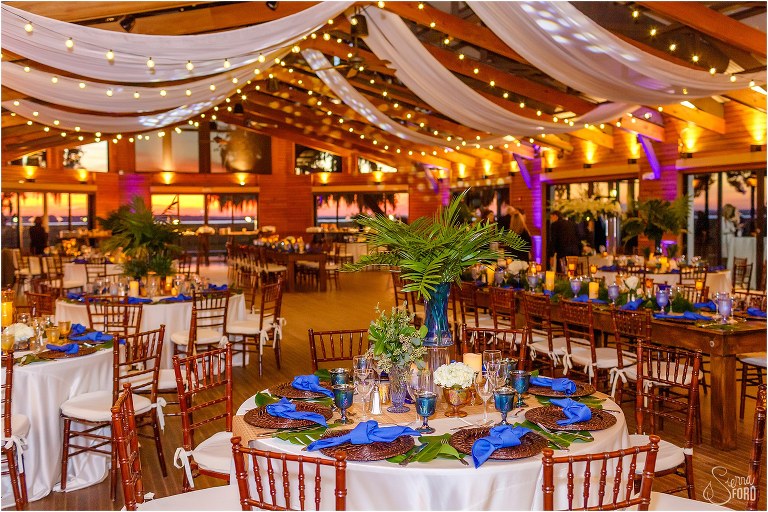 reception room at Walker's Landing with blue details and market lights at Amelia Island wedding