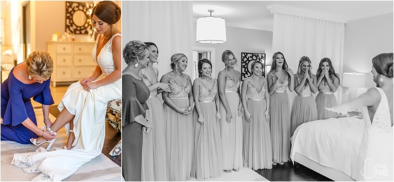 on left, mother of the bride buckles bride's shoes, on right, bridesmaids see bride for first time in gown before Amelia Island wedding