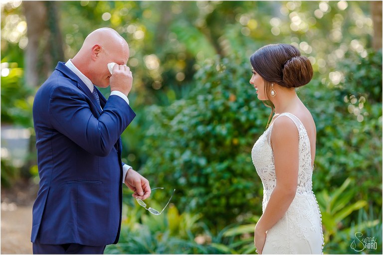 father of the bride wipes away tears when he sees bride for the first time before Amelia Island wedding