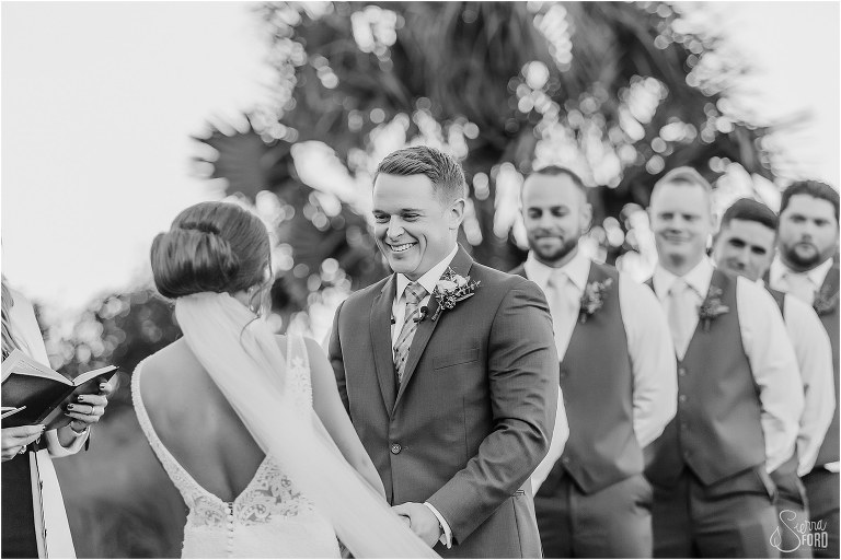 groom smiles at bride during Amelia Island wedding ceremony