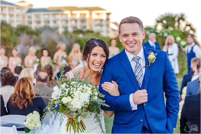 bride & groom smile at end of aisle after Amelia Island wedding ceremony