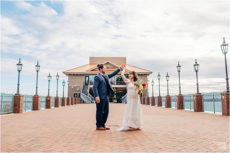 groom spins bride at Tavares Pavilion wedding on pier at Florida elopement