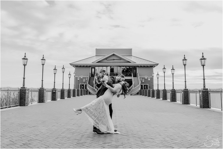 groom dips bride and kisses her on Tavares Pavilion pier at Florida elopement