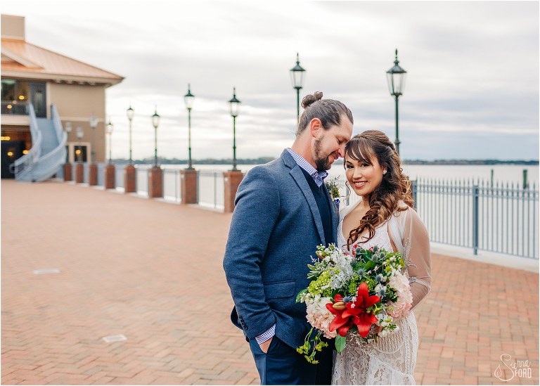 groom nuzzles bride's temple on pier after Florida elopement