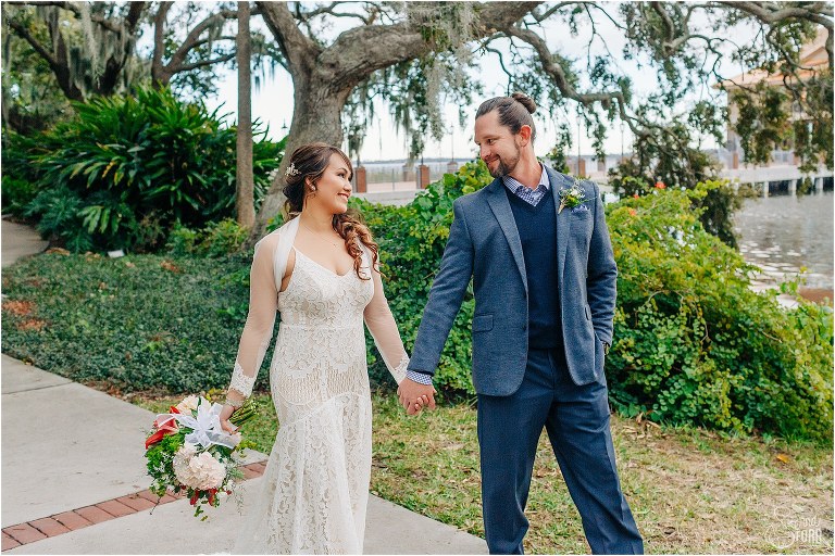 bride & groom stroll hand in hand through Wooten Park during Florida elopement