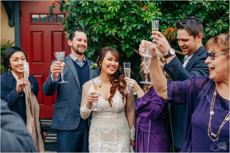 bride & groom cheers with their loved ones at Florida elopement