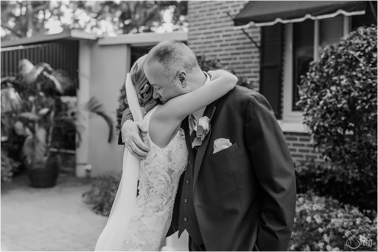 father of the bride hugs daughter before Town Manor wedding