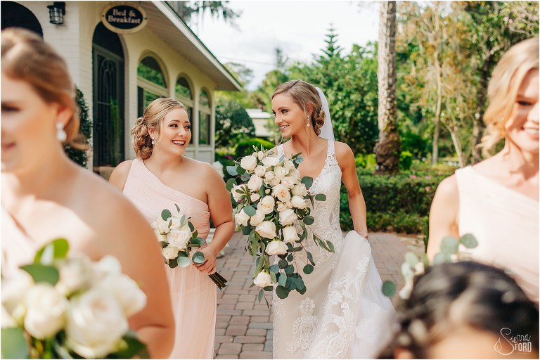 bride shares smile with maid of honor before Town Manor wedding