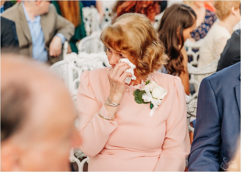 loved ones wipe tears away during emotional Town Manor wedding ceremony