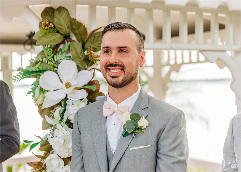 groom grins from ear to ear as bride comes down aisle at Town Manor wedding ceremony