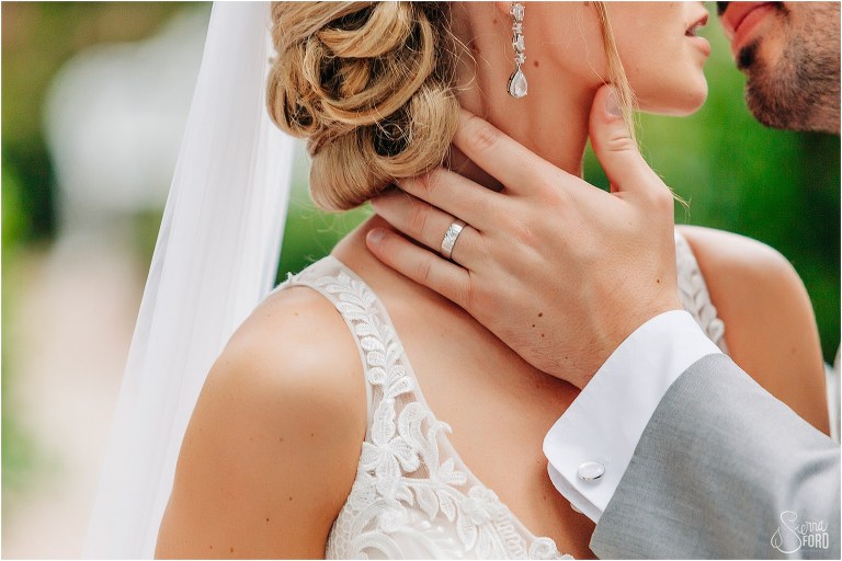 groom caresses bride's face as he leans in for a kiss at Town Manor wedding