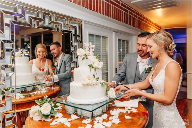 bride & groom giggle as they cut cake at Town Manor wedding reception