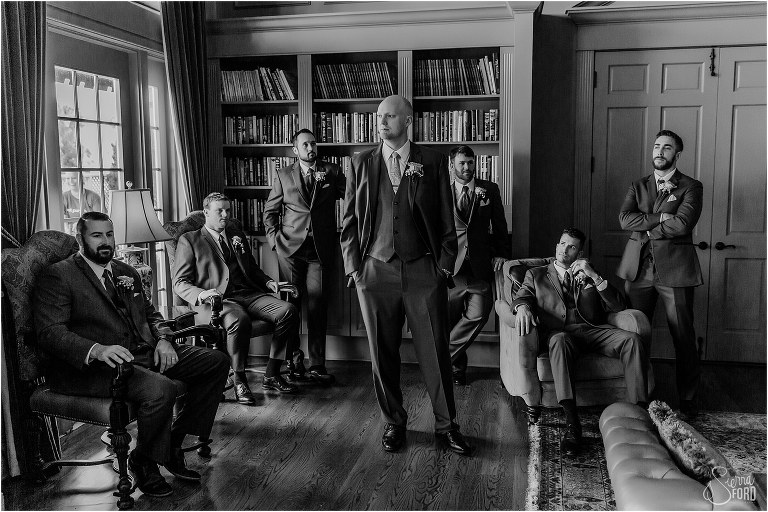 groom & groomsmen lounging around the library before River House wedding