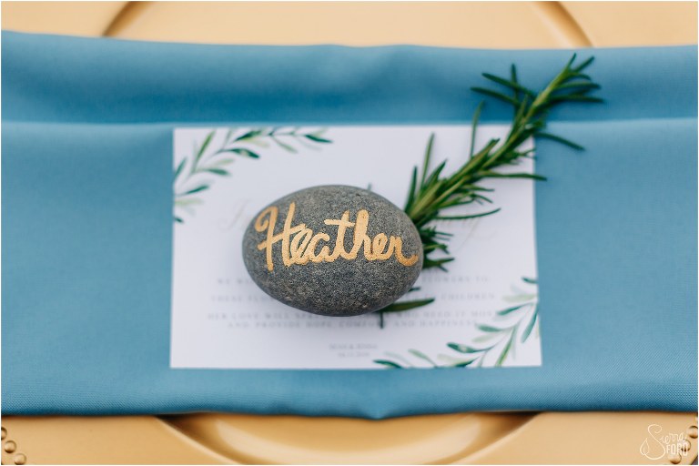 personalized stone place settings with blue napkins and herb sprig for Winter Park wedding reception