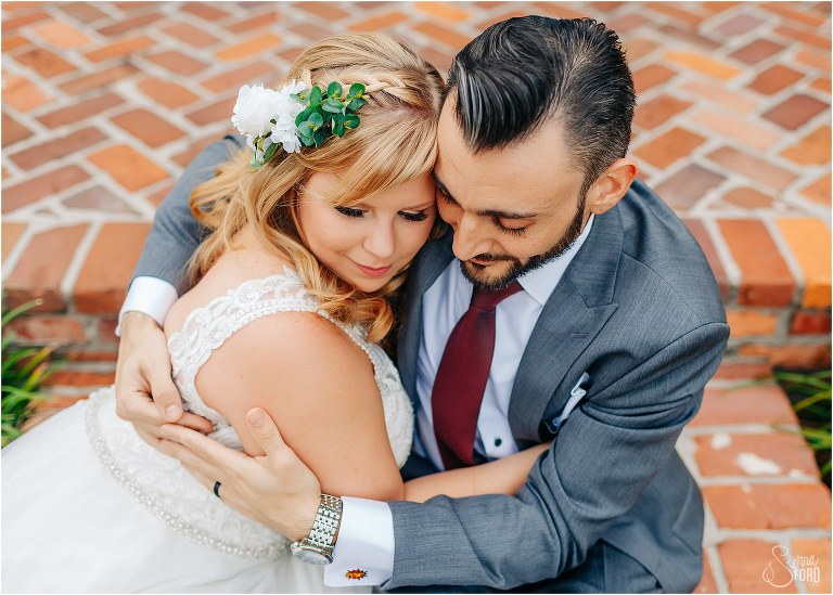 bride & groom snuggle up close on steps of Casa Feliz at Winter Park wedding