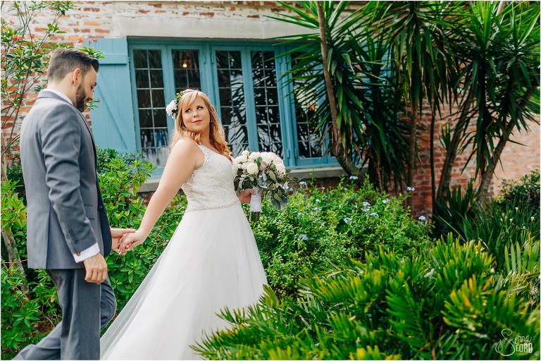 bride leads groom through Casa Feliz gardens at Winter Park wedding