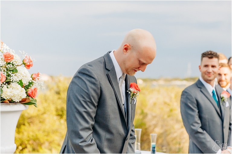 groom becomes emotional as he sees his bride coming down the aisle during River House wedding ceremony