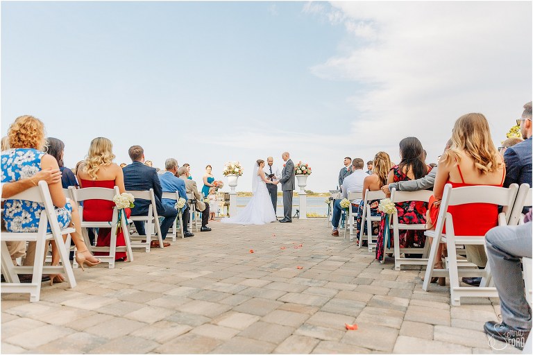 bride & groom exchange vows on the water during River House wedding ceremony