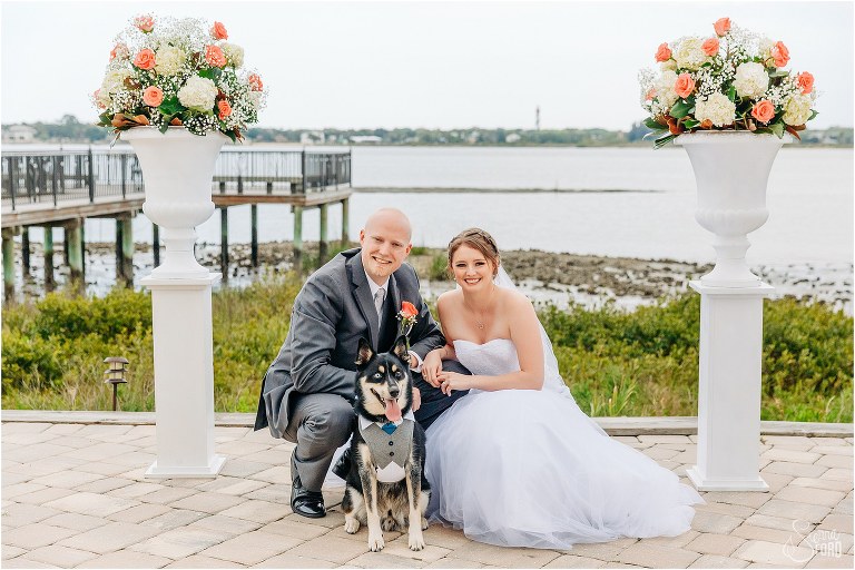 bride & groom smile with their beloved dog who doubled as groomsman at River House wedding