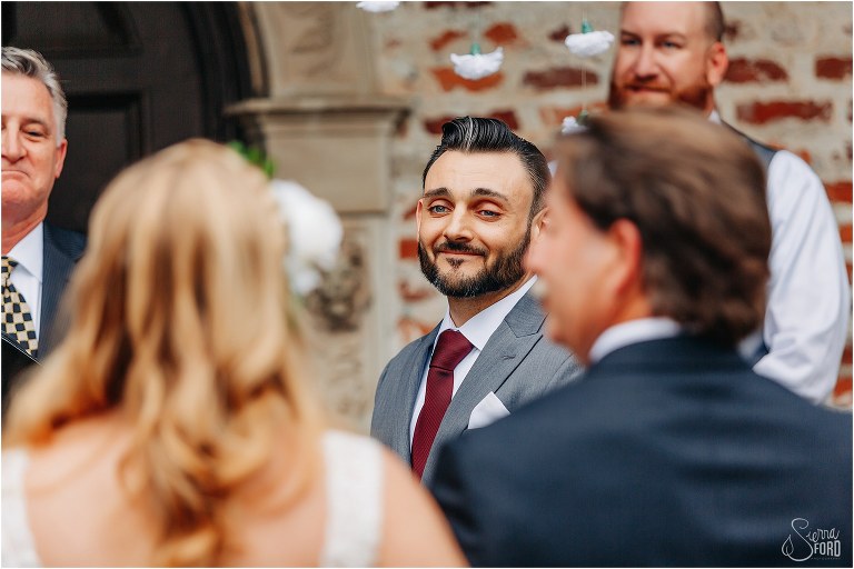 groom watches as his bride comes down the aisle with her father at Winter Park wedding ceremony