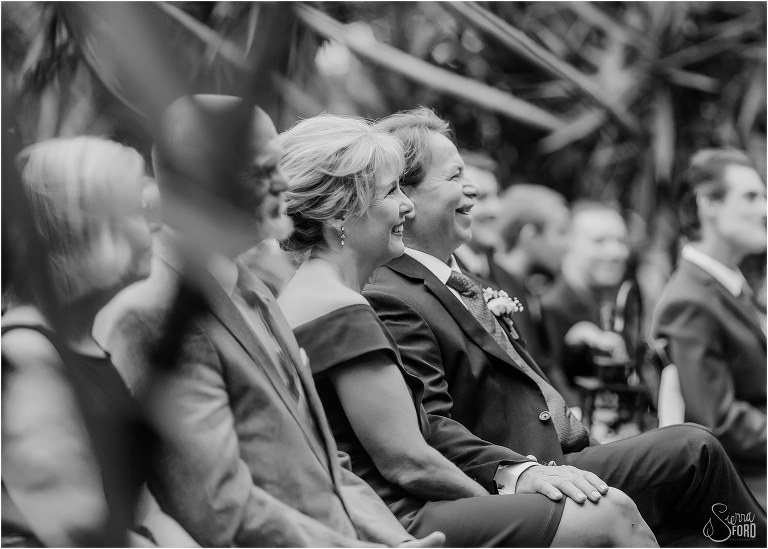 bride's mother & father smile lovingly during Winter Park wedding ceremony