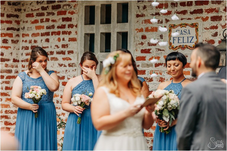 bridesmaids wipe tears from their eyes during emotional Winter Park wedding ceremony