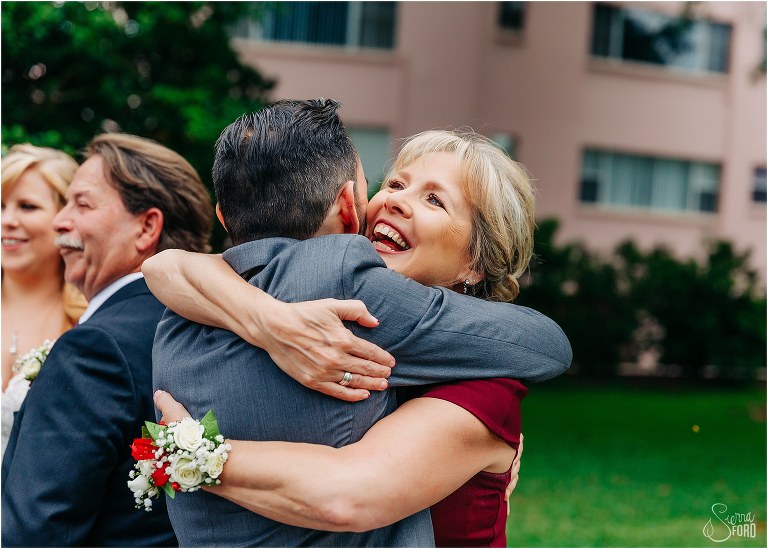 mother of the bride hugs new son-in-law after Winter Park wedding ceremony