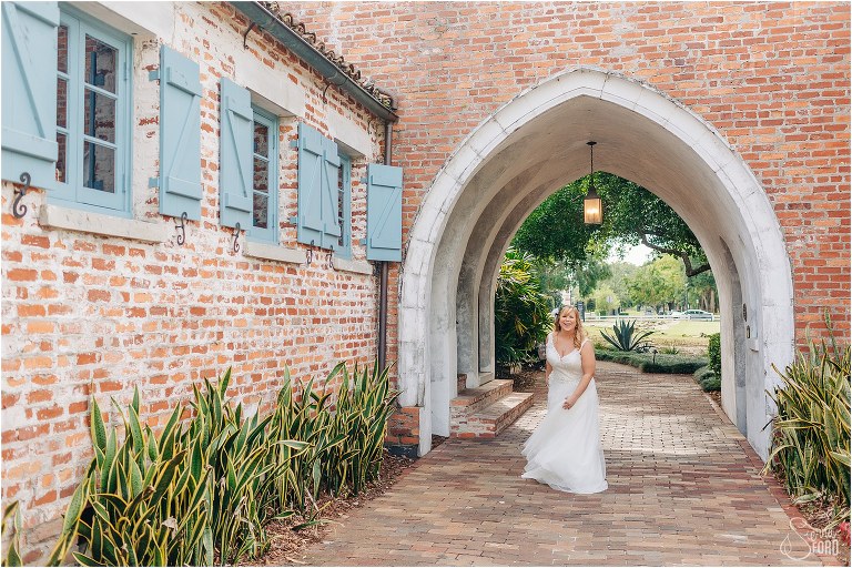 bride twirls in Casa Feliz archway before Winter Park wedding