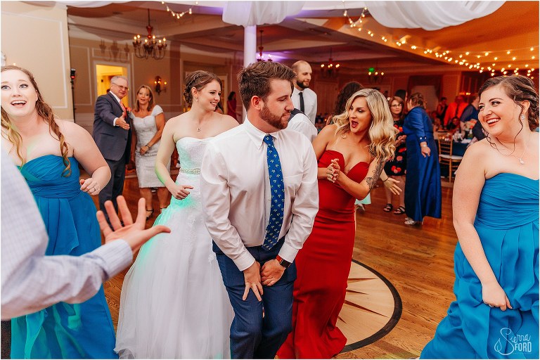 bride shows off dance moves with her guests at River House wedding reception