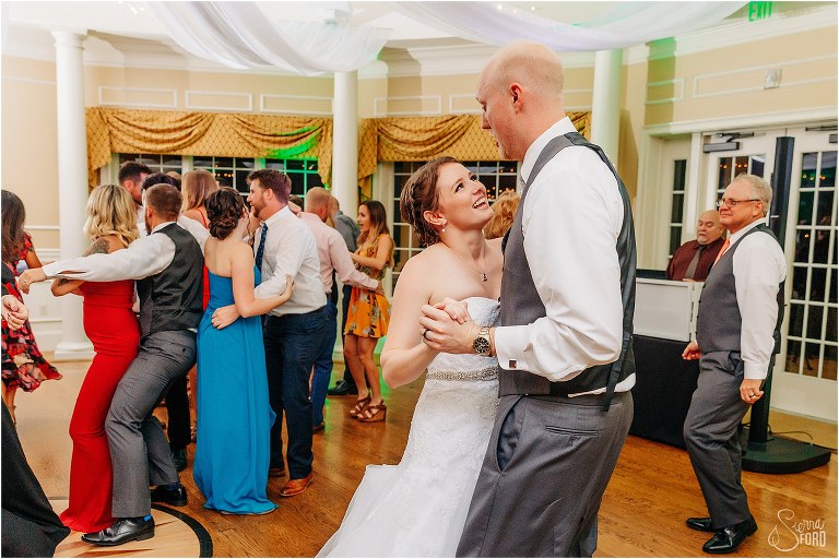 bride & groom dance together during River House wedding reception