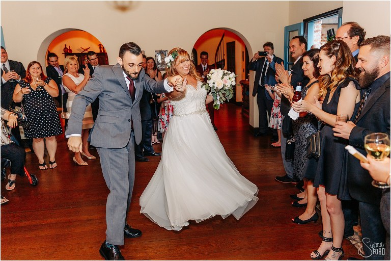 groom dances as he leads the bride into their Winter Park wedding reception