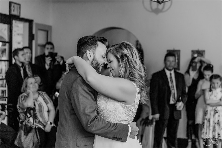 groom smiles as he sings to the bride during their first dance at Winter Park wedding reception